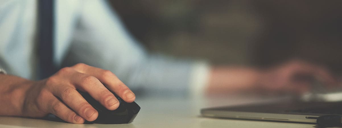 Person using computer mouse to scroll website