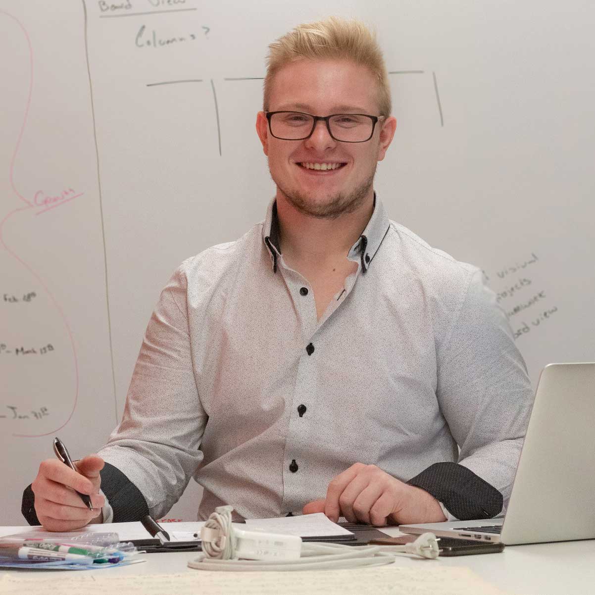 cody-whiteboard Project Manager, Cody Butler creating wireframes on whiteboard