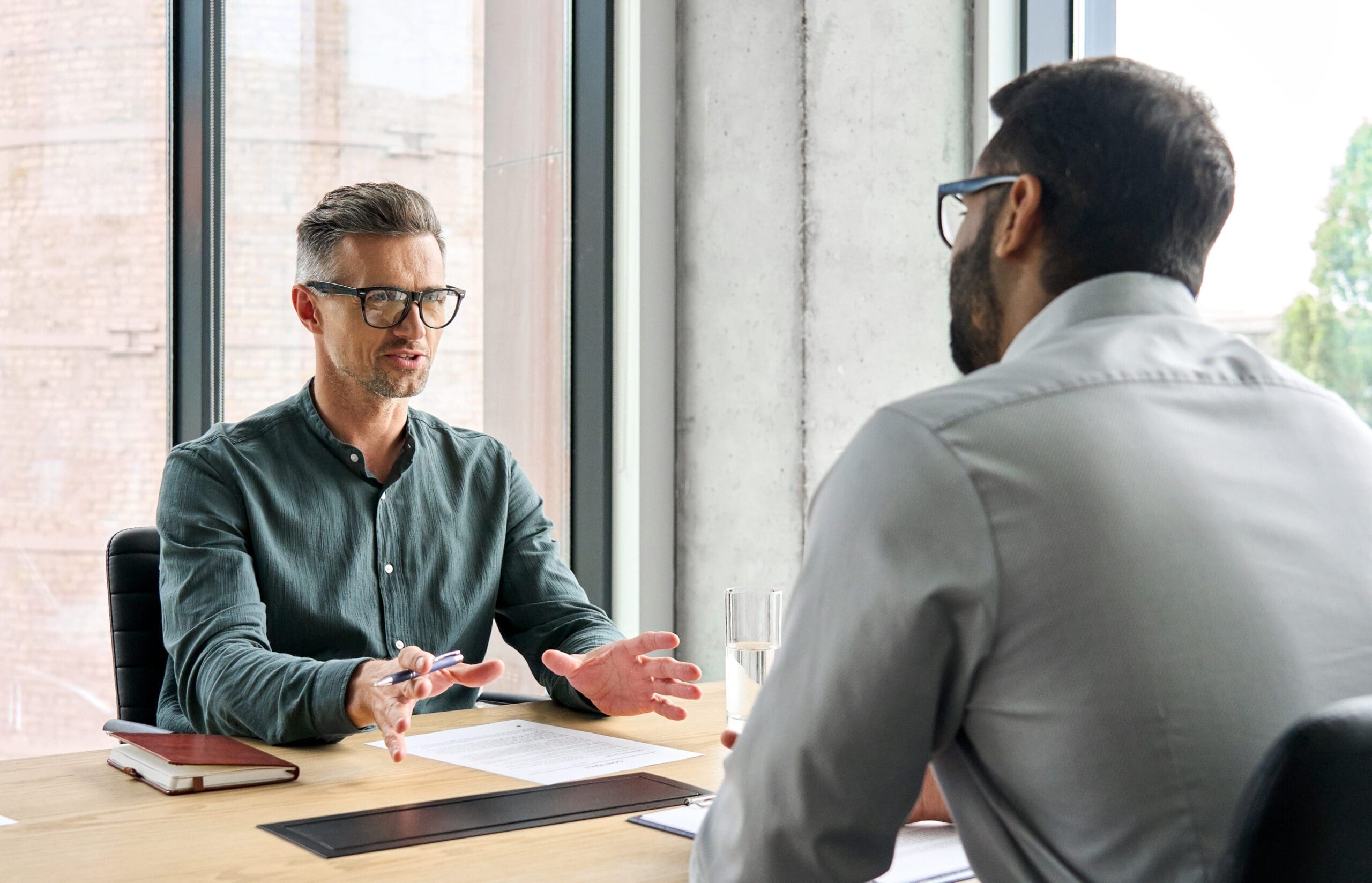 Manager adviser consulting client discussing financial partnership at meeting. manager adviser consulting with client